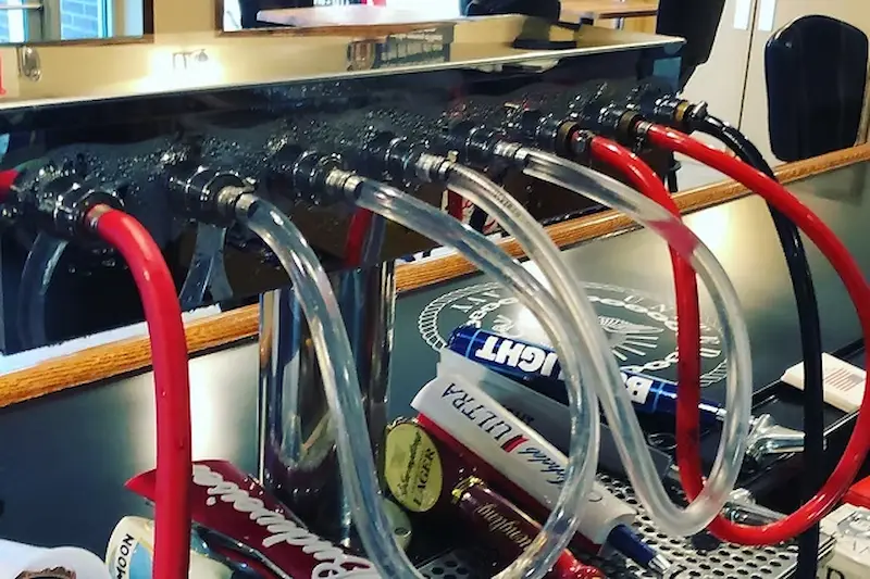 Jumper lines looped between faucets on a bar tap tower during draft beer line cleaning